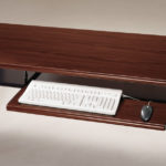 image is of a wooden keyboard tray mounted to a desk