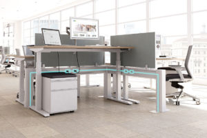 Image is of an adjustable desk in an office space