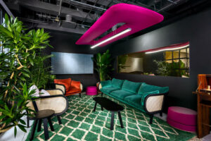 Image is of BUZZI SPACE showing plant life and lighting in a modern setting.
